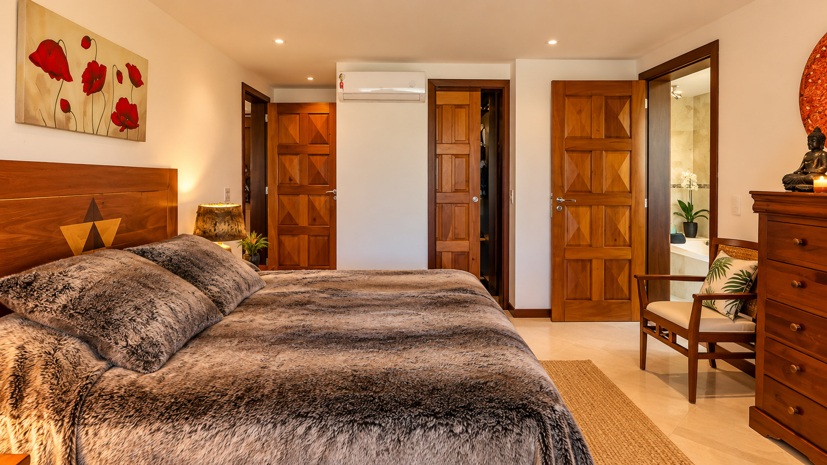 Stilvolles Schlafzimmer mit Meerblick, großzügigem Doppelbett, edlen Holzmöbeln und eigenem Badezimmer in einer exklusiven Strandresidenz in Bahia.